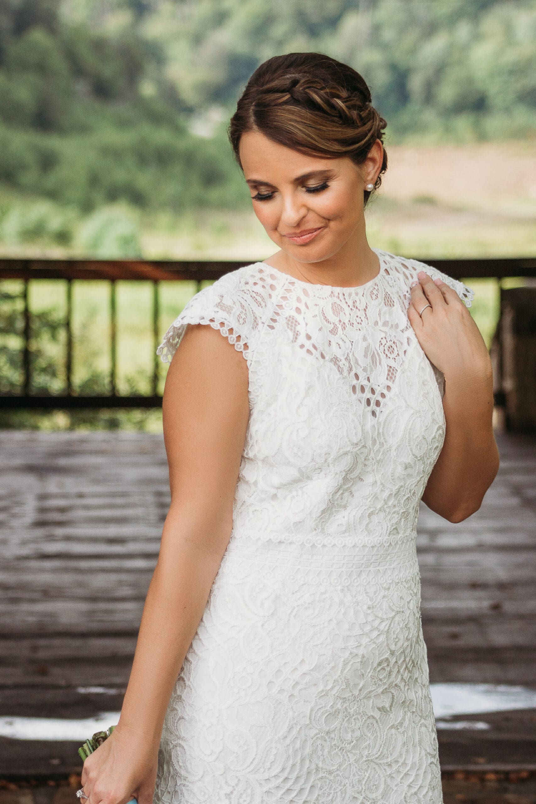 Bride at elopement standing under gazebo smiling big.