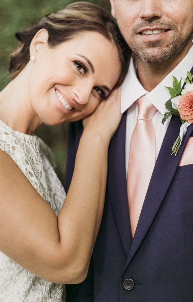 Bride and Groom having a moment in the woods surrounded by greenery having an intimate moment at their elopement.