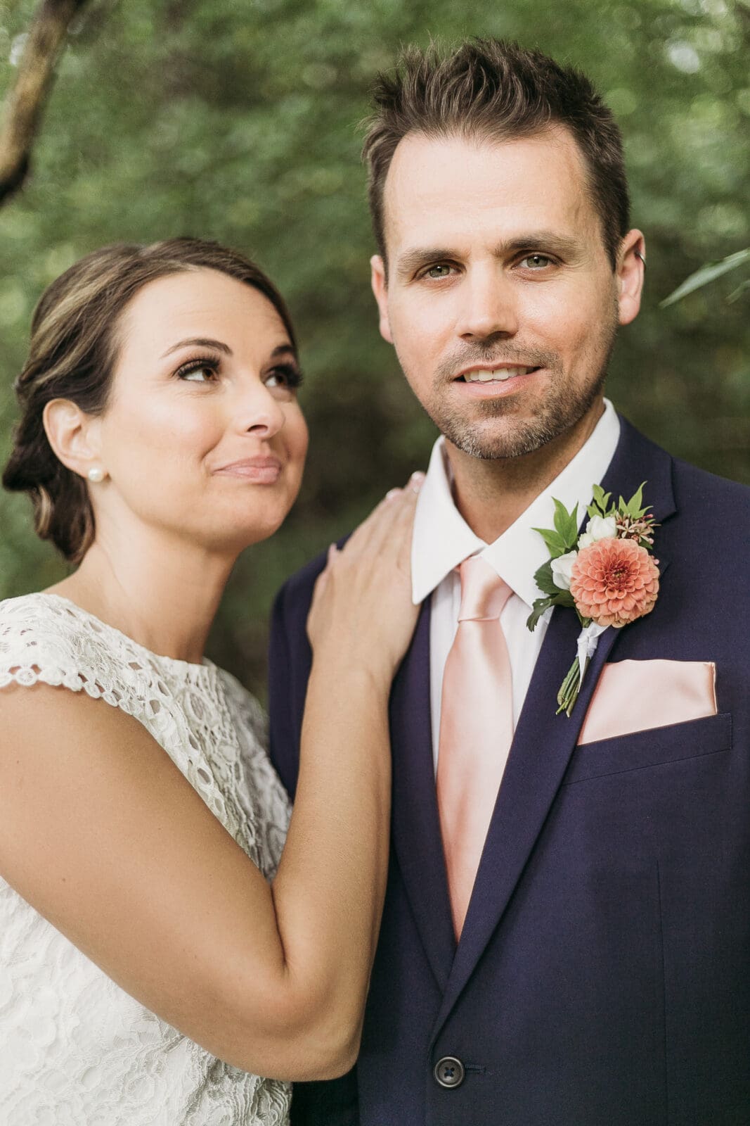 Bride and Groom having a moment in the woods surrounded by greenery having an intimate moment at their elopement.