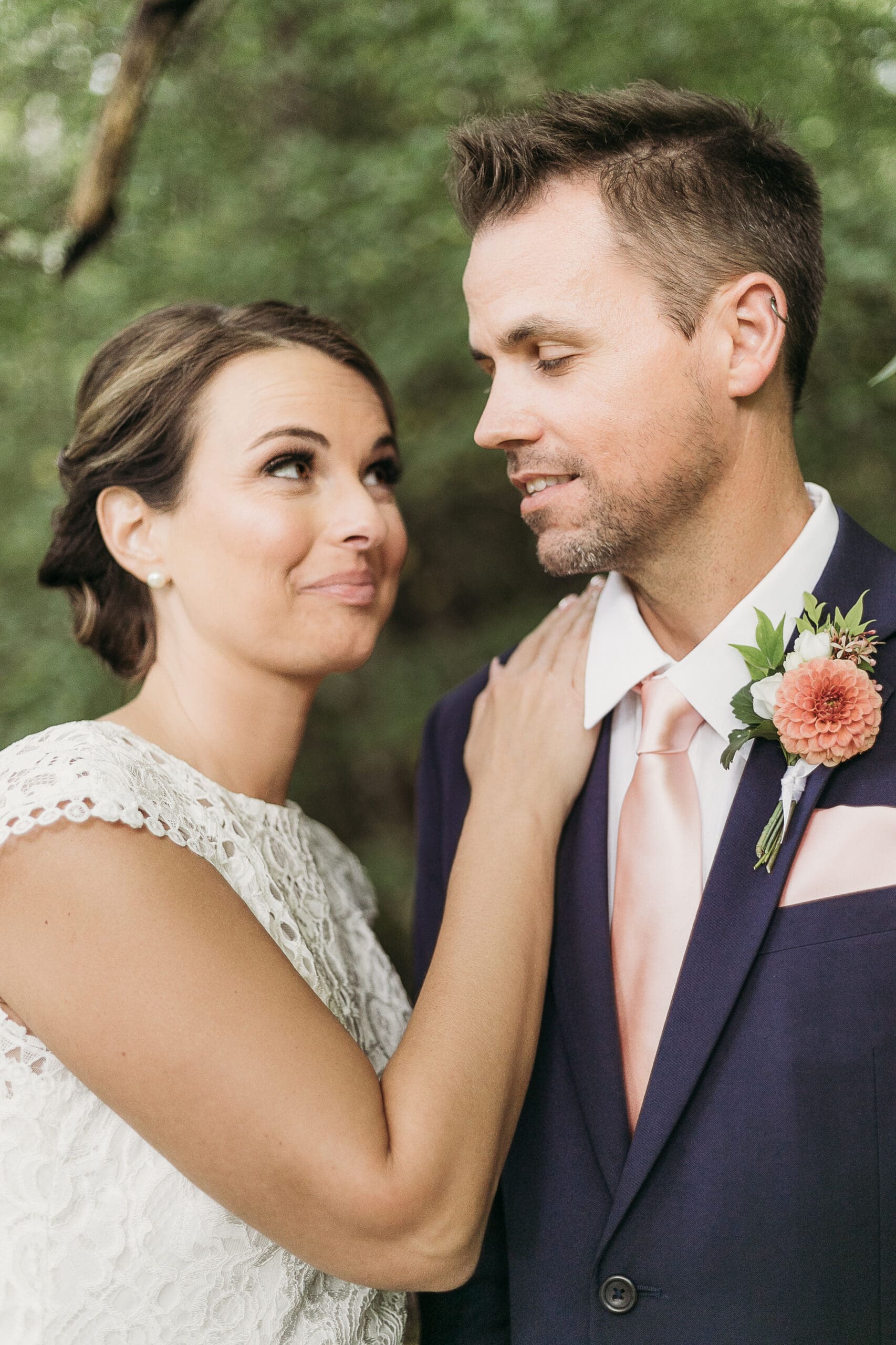 Bride and Groom having a moment in the woods surrounded by greenery having an intimate moment at their elopement.