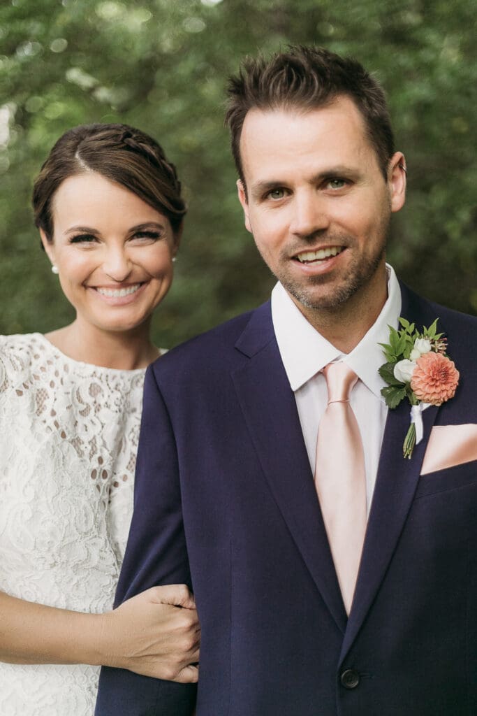 Bride and Groom having a moment in the woods surrounded by greenery having an intimate moment at their elopement.