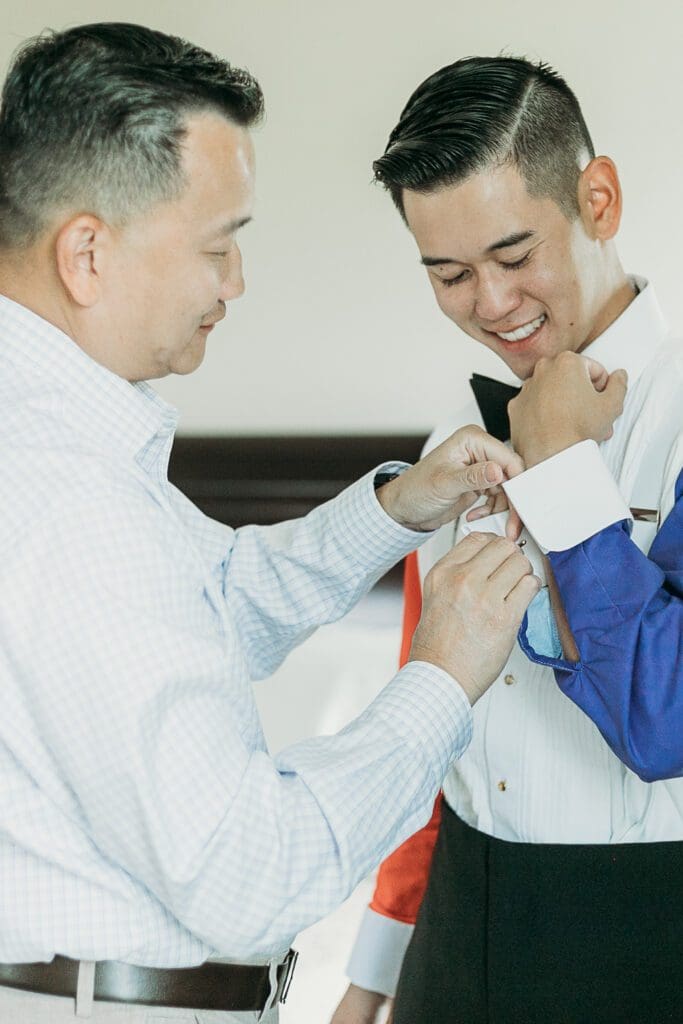 Dad helping groom getting ready for his wedding day.