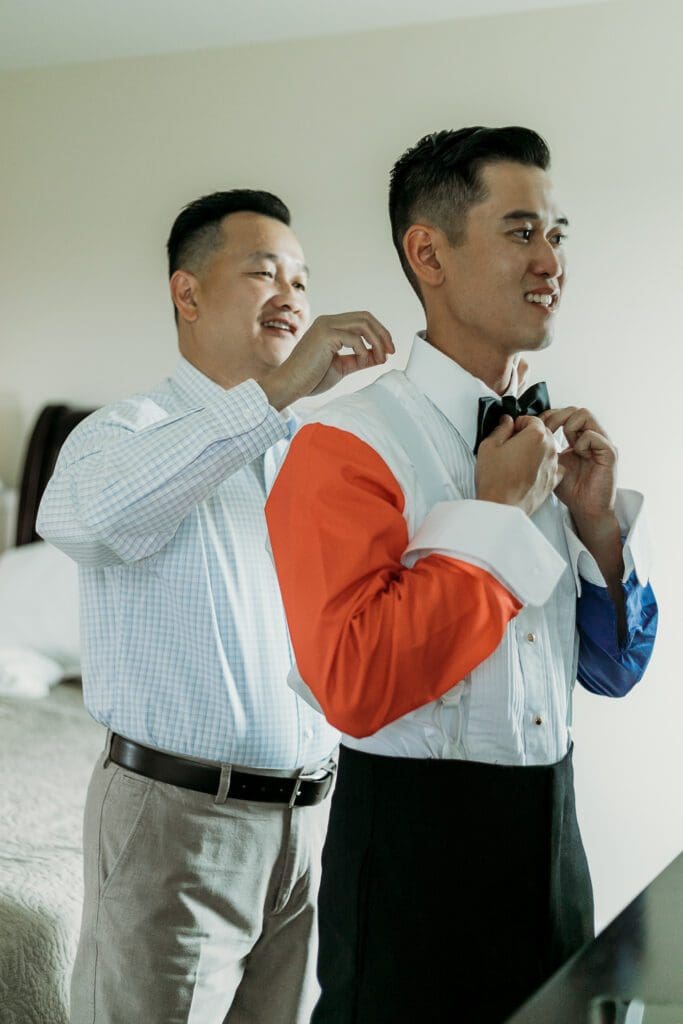 Dad helping groom getting ready for his wedding day.