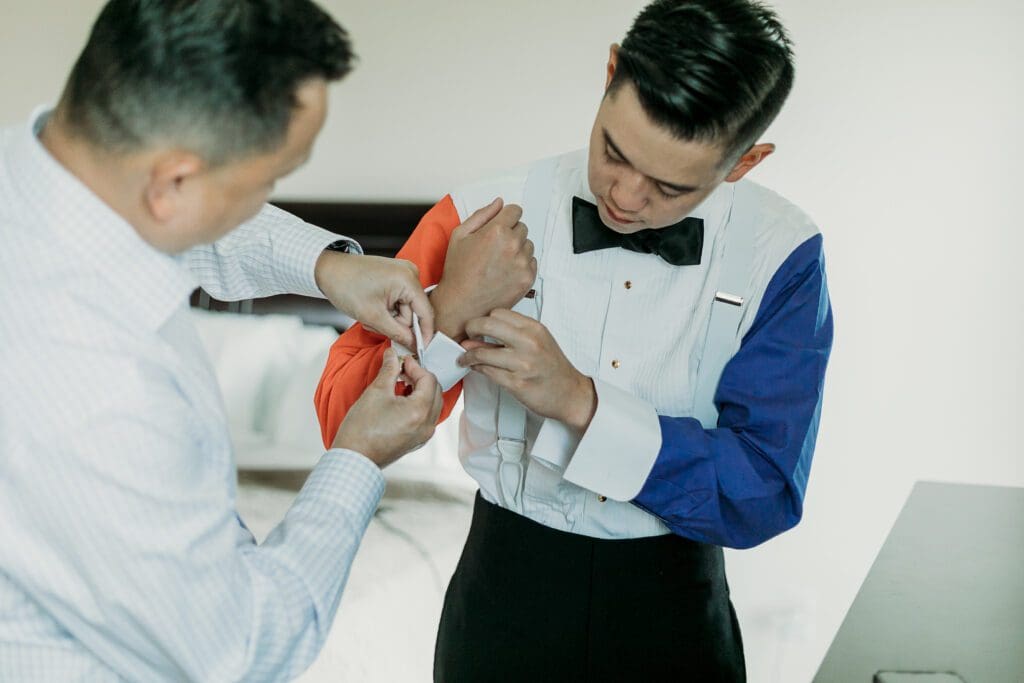 Dad helping groom getting ready for his wedding day.