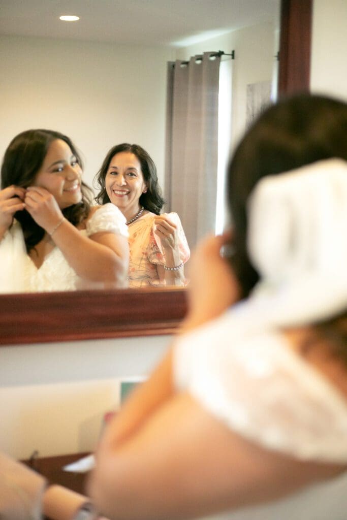 Mom helping bride getting ready for her wedding day.
