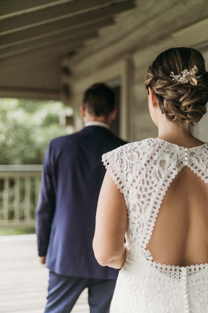 Couple getting married under gazebo eloping in front of the mountains with their son.