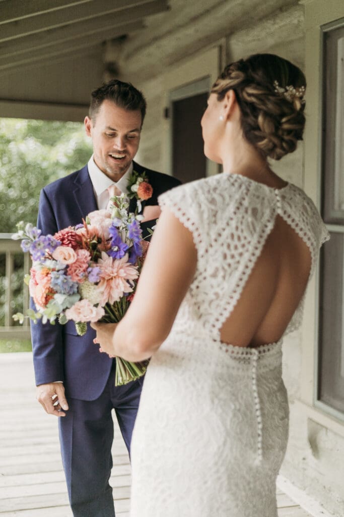 Couple getting married under gazebo eloping in front of the mountains with their son.