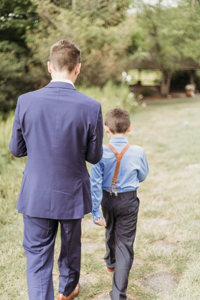 Couple getting married under gazebo eloping in front of the mountains with their son.
