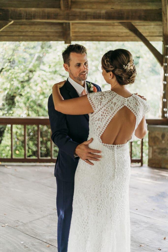 Couple getting married under gazebo eloping in front of the mountains with their son.