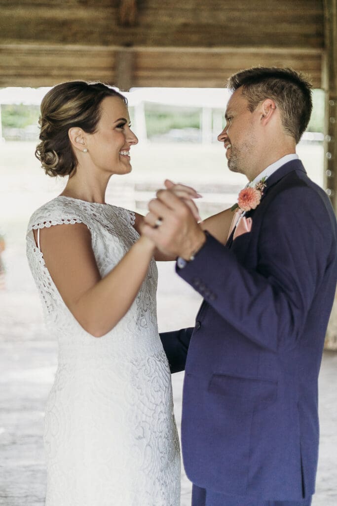 Couple getting married under gazebo eloping in front of the mountains with their son.