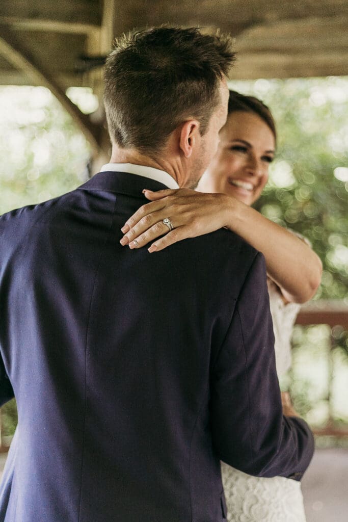 Couple getting married under gazebo eloping in front of the mountains with their son.