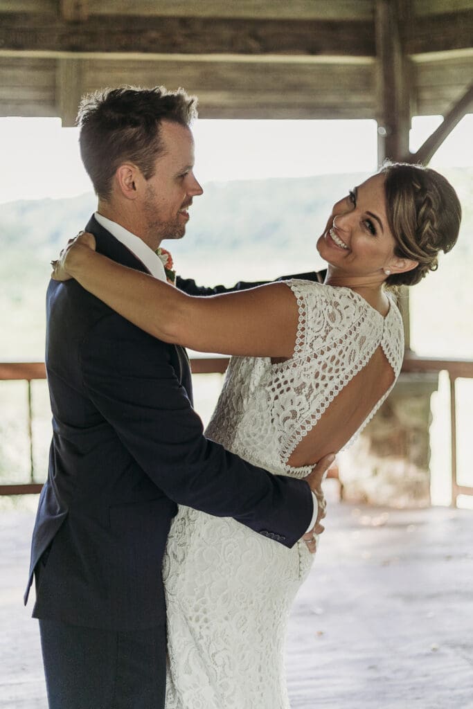 Couple getting married under gazebo eloping in front of the mountains with their son.