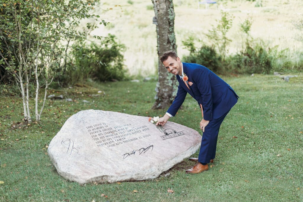 Couple getting married under gazebo eloping in front of the mountains with their son.