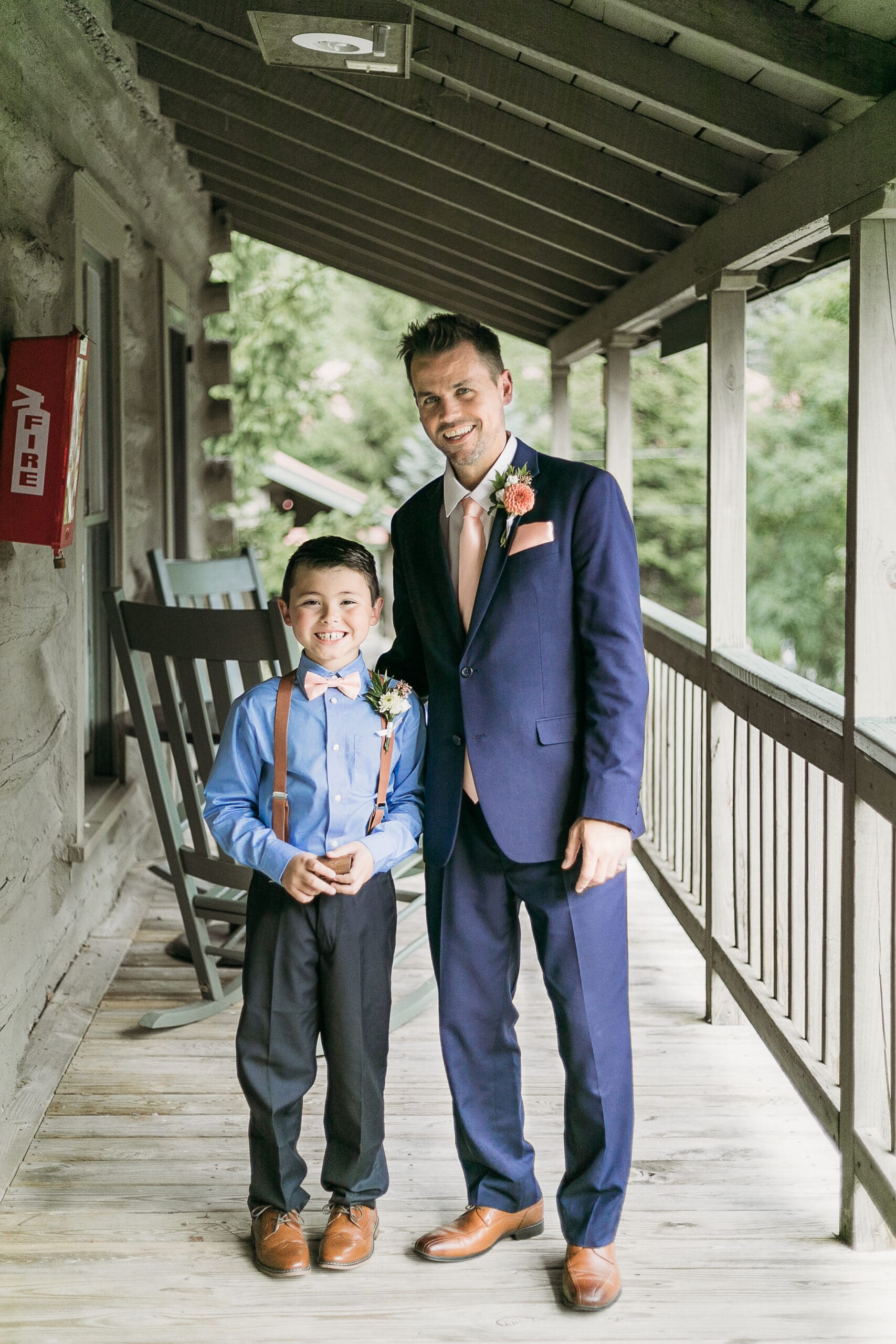Couple getting married under gazebo eloping in front of the mountains with their son.