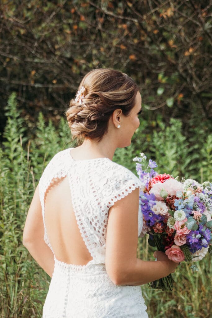 Couple getting married under gazebo eloping in front of the mountains with their son.