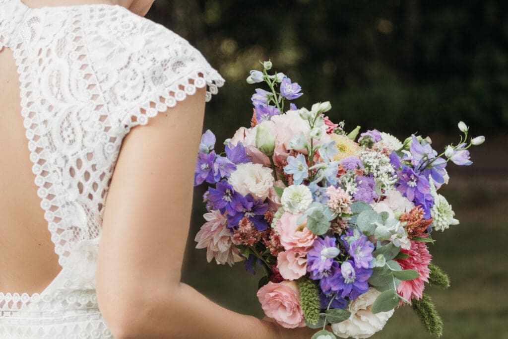 Couple getting married under gazebo eloping in front of the mountains with their son.