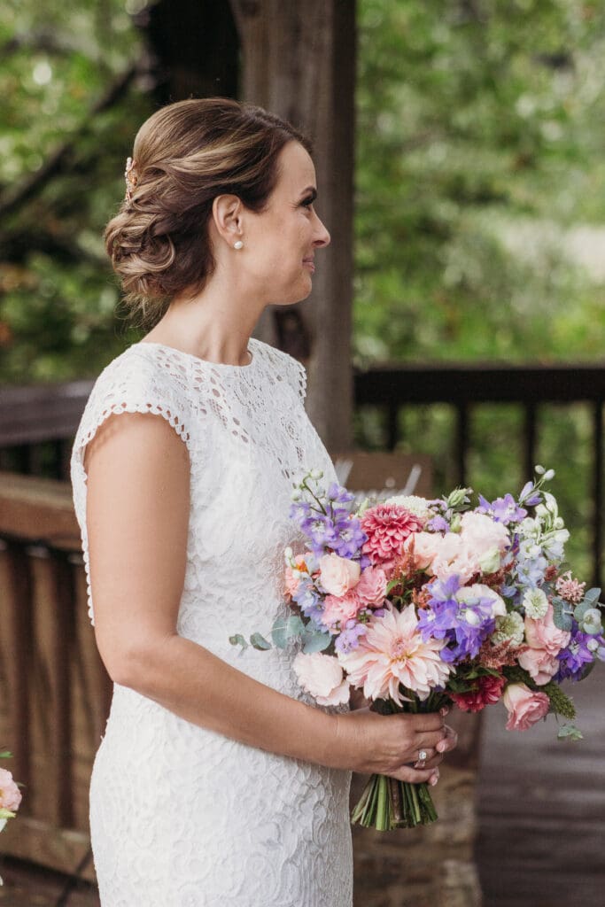 Couple getting married under gazebo eloping in front of the mountains with their son.