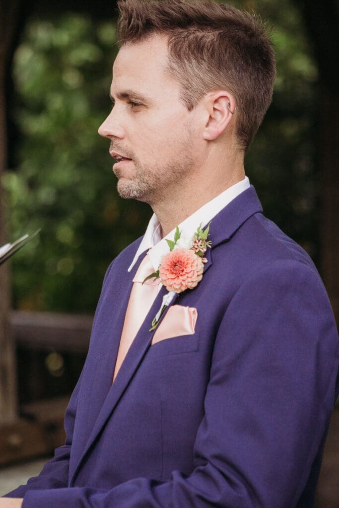Couple getting married under gazebo eloping in front of the mountains with their son.